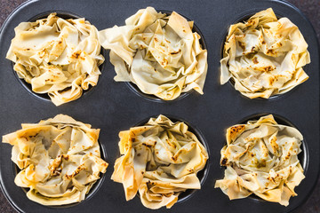 plant-based food, filo pastry cups with vegan filling in muffin tray just out of the oven