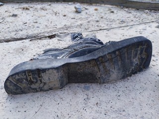 old dirty rubber boots on the beach