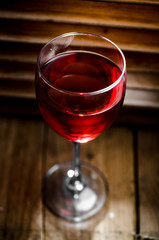 Glass of red italian wine on wood background