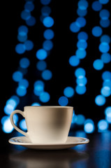 White coffee cup with black background and blue