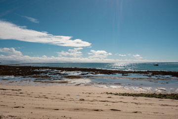 Deserted beach with beautiful blue sky