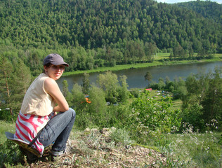 Young woman on the top of mountains and camping outdoors for relax summer time. Freedom. Enjoyment. Relaxing in mountains . Sunshine Daydreaming