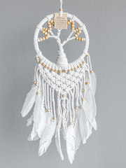 Dreamcatcher, an American native amulet made of feathers, leather beads, and ropes with the symbol...