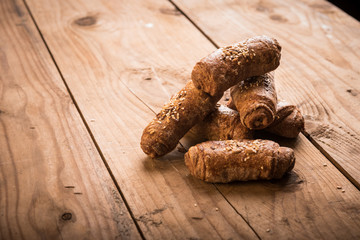 Crunchy bacon pastry rolls with sesame seeds