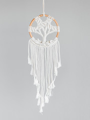 Dreamcatcher, an American native amulet made of feathers, leather beads, and ropes with the symbol...