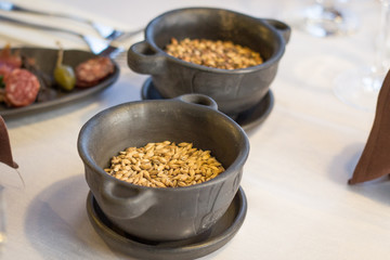 Two stone bowls with fresh and yellow wheat grain