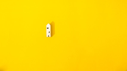 Home on yellow background top view minimalistic concept