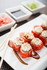Uramaki sushi ikura maki with chilli sauce