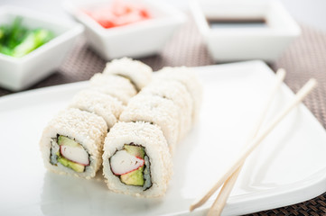 Uramaki sushi california sesame maki on a dish © Markel