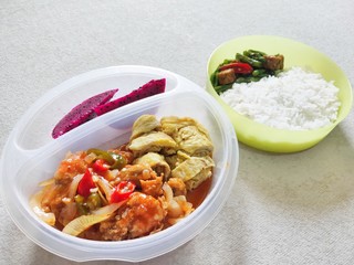 Rice, Sweet and sour shrimp, omelette and dragon fruit for lunch at the office
