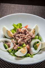 Tuna salad with eggs, tomatoes, salad leaves and onions
