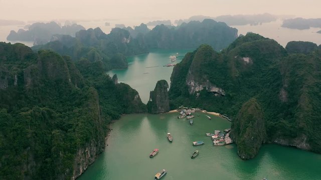 HALONG BAY, VIETNAM - APRIL, 2020: Aerial panorama view of the pier in the rocky islands of Halong Bay in Vietnam.