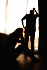 blur of  Silhouettes of difficult relationship couple quarreling in dark bedroom at sunset , Stay at home quarantine coronavirus pandemic prevention