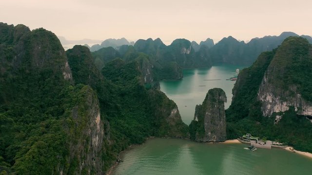 HALONG BAY, VIETNAM - APRIL, 2020: Aerial panorama view of the pier in the rocky islands of Halong Bay in Vietnam.