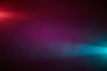 Against a dark lilac background, piercing rays of light red and light blue