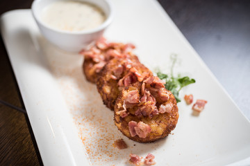 Potato rosti with bacon and sauce, deep fried