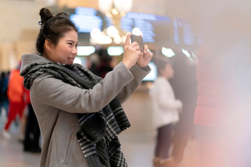 attractive beautiful asian female woman travel alone enjoy sight seeing and look for direction in...