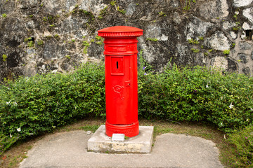 Fototapeta na wymiar Bright red roadside mail posting box on Penang Hill