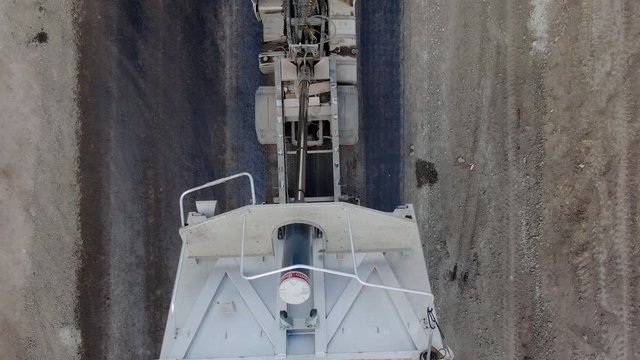 4K video. Top view of road works with asphalt paver.