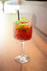 Cold and icy red mohito cocktail with orange