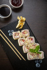 Obraz na płótnie Canvas Sweet sushi rolls, strawberries, banana, chocolate