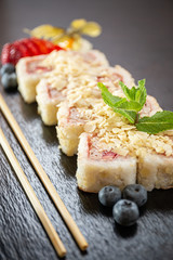 Sweet sushi rolls, strawberries, banana, chocolate