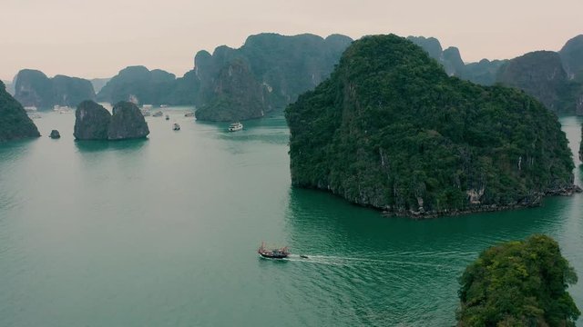 HALONG BAY, VIETNAM - APRIL, 2020: Aerial panorama view of rocky islands with tropical forests of Halong Bay in Vietnam.