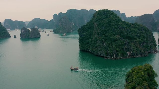 HALONG BAY, VIETNAM - APRIL, 2020: Aerial panorama view of rocky islands with tropical forests of Halong Bay in Vietnam.