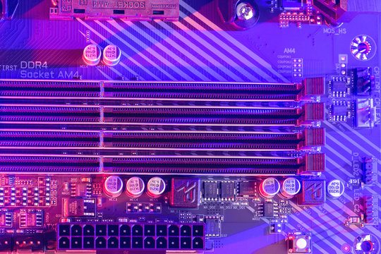  DDR4 RAM. Close-up of empty four Slots for ddr4 RAM, random access memory stick slots with a neon colored backlight (pink ans purple). Power to the motherboard. Technological background