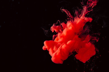 paint stream in water, colored ink cloud, abstract background, process of mixing multicolored dye on a black background