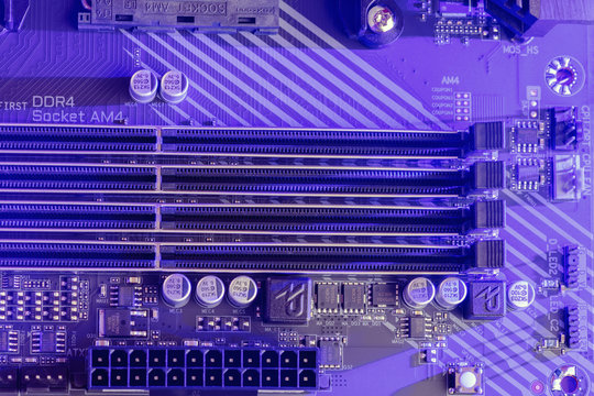 DDR4 RAM. Close-up of empty four Slots for ddr4 RAM, random access memory stick slots with a neon lilac and purple backlight. Technological background