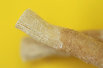 Miswak natural toothbrush close-up on a bright yellow background.Dental hygiene.Miswak sticks  plant.Vegetable toothbrush.  hygiene and health by nature.