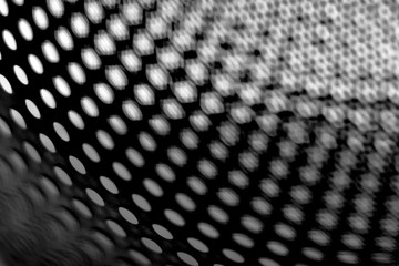 Abstract surface with round holes in black and white. Black and white minimalism.