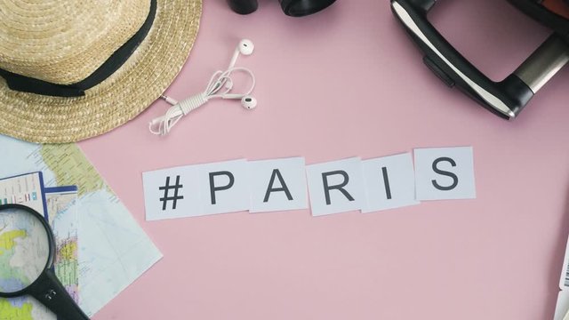 Top view hands laying on pink desk word PARIS