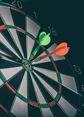 To the point concept. Green and red darts in the bullseye target. Successful missions based in...