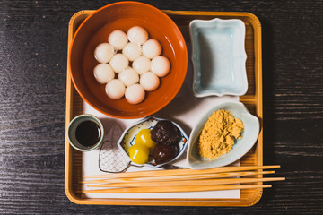 Traditional Japanses dessert made from sticky rice flour and brown sugar on wooden table