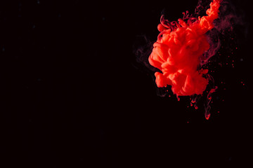 paint stream in water, colored ink cloud, abstract background, process of mixing multicolored dye on a black background