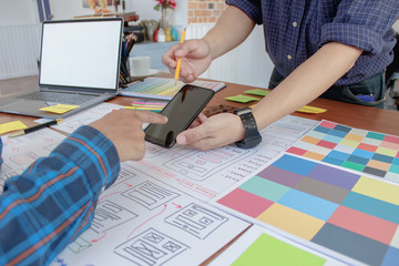 Soft Focus and Blur,A group of web designers are working together to develop a mobile responsive website with UI/UX Front End Designer Previewing. Website development concept UI/UX front end designer.