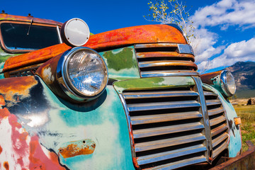 Old  Multicolored Pickup With Mountains, Taos, New Mexico, USA