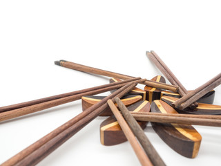 Isolated of Wooden chopsticks on chopstick rest arrange in flower shape