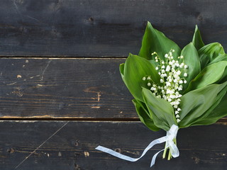 Floral spring photo. A bouquet of fragrant lilies of the valley on a dark background.
