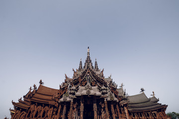 Fototapeta na wymiar Thailand, Pattaya December 2019 Fragment of the Temple of truth in Pattaya. A huge wooden temple with carved decorations. Buddhist temple. Religious building in Pattaya Tourist attraction of Thailand