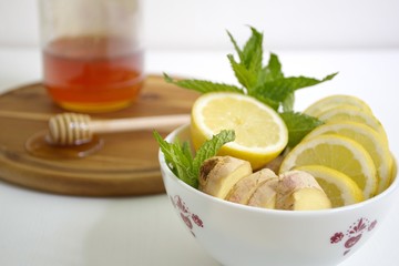 Ginger, lemon, mint and honey on table