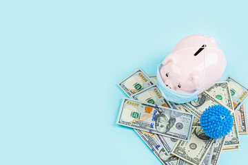 Piggy bank and cash money one hundred dollars bills on blue background. Flat lay, top view, overhead, mockup, template. Concept of Financial crisis after end coronavirus covid-19 pandemic lockdown