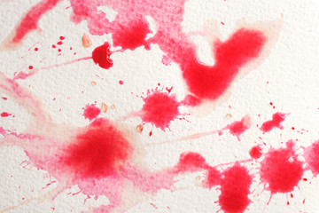 Abstract liquid drops splash fresh pomegranate juice on a white texture paper background for watercolor. Artistic decoration or backdrop. Banner for text, grunge element. Red and pink colors