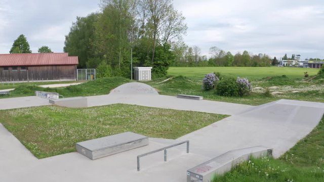 Wide shot of the skatepark in Erbach, Germany. The park is empty and closed due to the corona crisis. Camera flies slowly over the park.