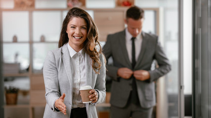 Portrait of beautiful businesswoman in office. Young businesswoman handshaking in office.