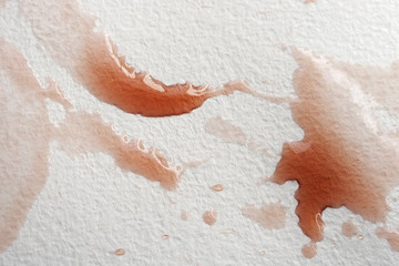 Abstract liquid drops splash fresh pomegranate juice on a white texture paper background for watercolor. Artistic decoration or backdrop. Banner for text, grunge element. Glare in reflection
