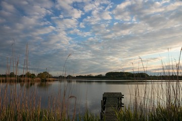 idyllic lake scenery with jetty in spring