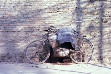 Old bicycle in front of old wall